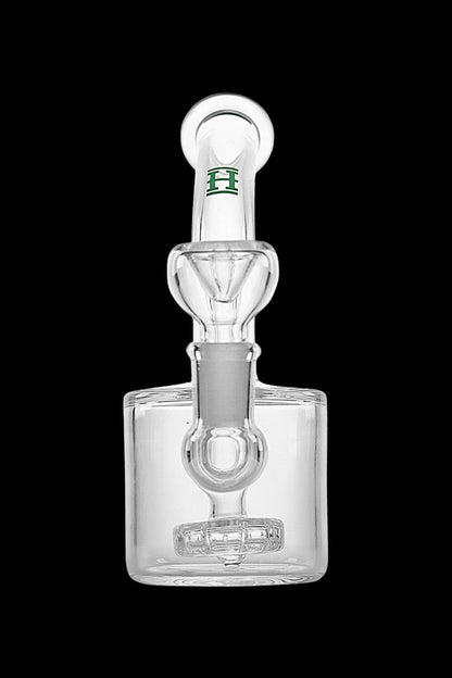 Clear glass bubbler with a honeycomb perc filter and green logo.