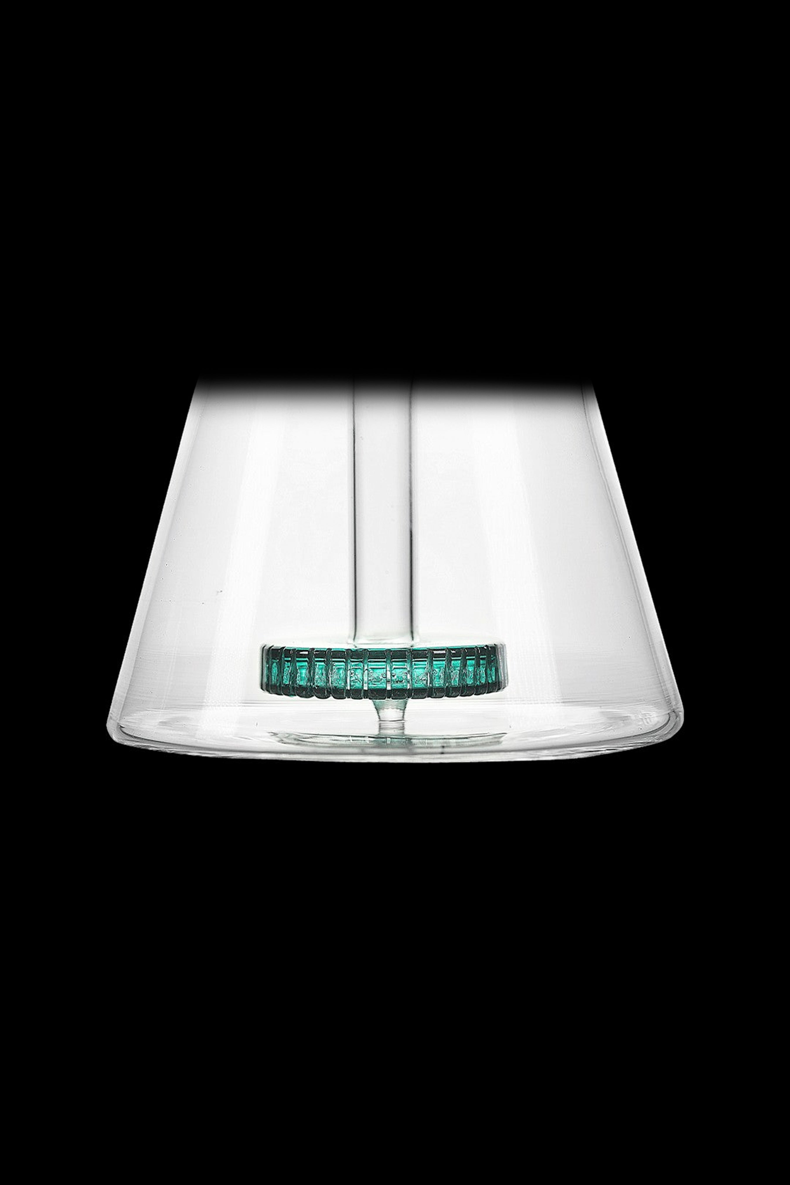 Clear glass cannabis water pipe with a green mouthpiece.