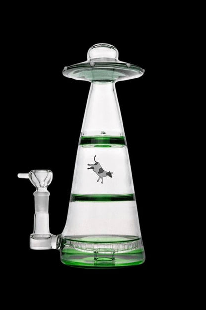 A glass water pipe shaped like a UFO with a cowboy graphic inside, accompanied by a glass bowl.