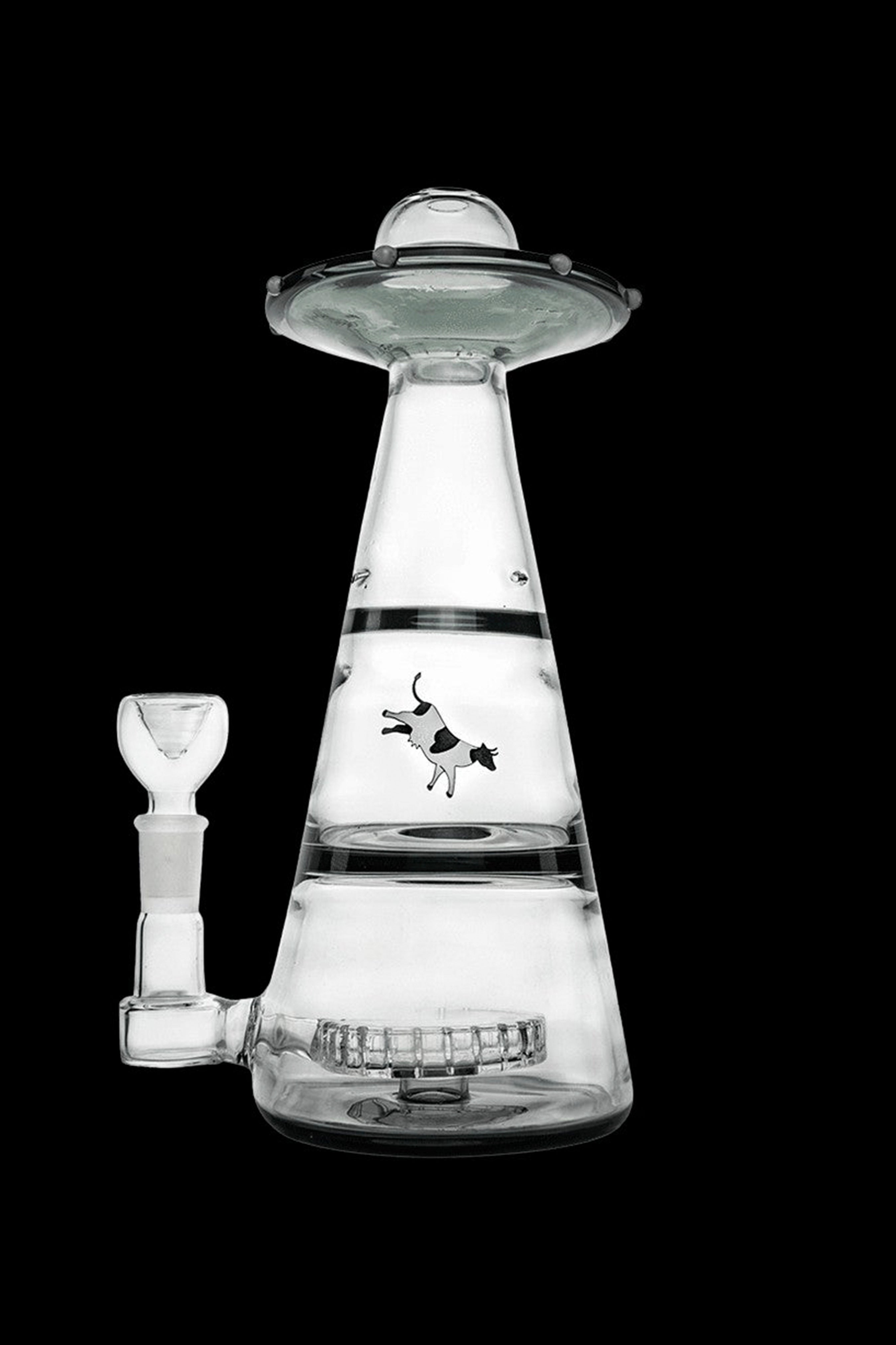 Glass water pipe shaped like a UFO with a cow graphic.