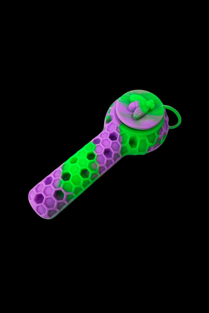 A vibrant green and purple silicone pipe with a honeycomb texture and a sculpted bee on top.