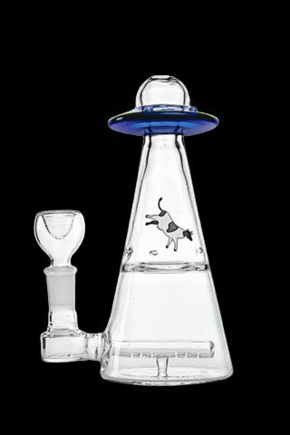 Clear glass water pipe shaped like a UFO with a cartoon cow graphic, and separate glass bowl.