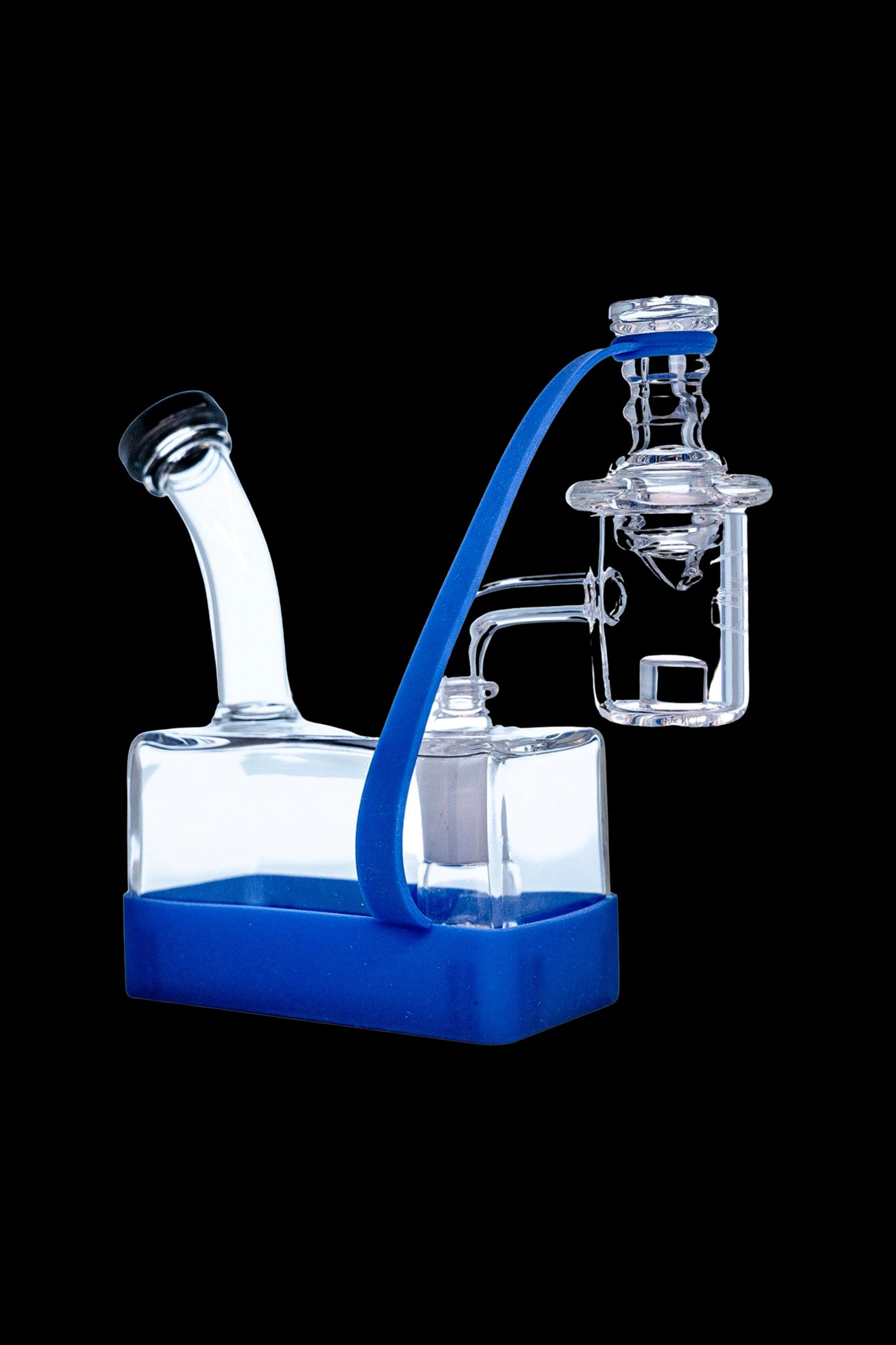 Clear glass dab rig with blue accents and silicone base.