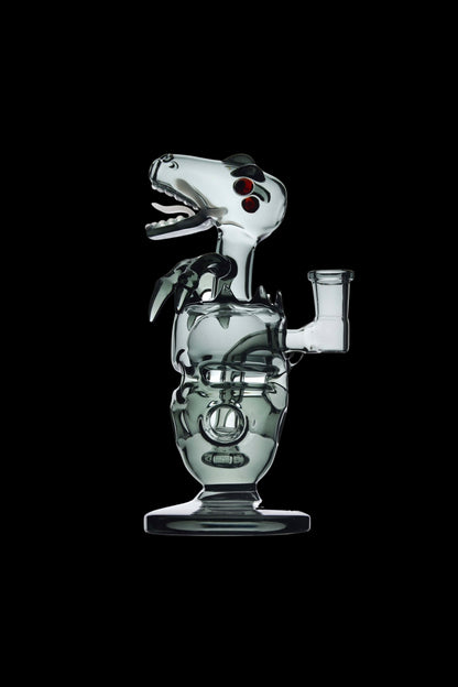 Side profile of the Calibear Fab Dino Rig glass sculpture with an open-mouthed dinosaur head and red eye accents against black.