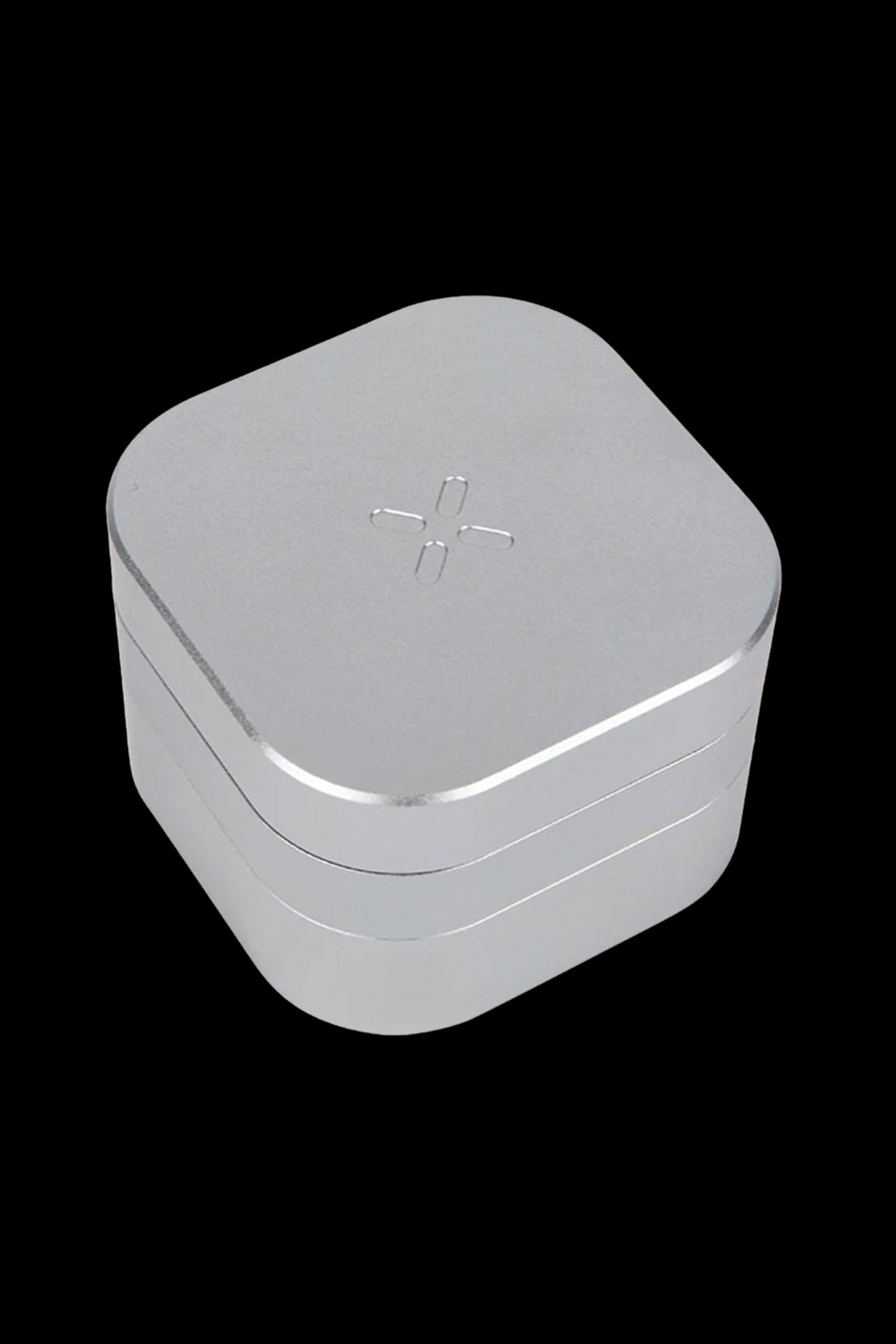 Silver cannabis storage container with a cross symbol on the lid.