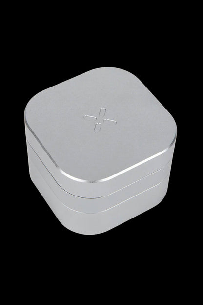 Silver cannabis storage container with a cross symbol on the lid.