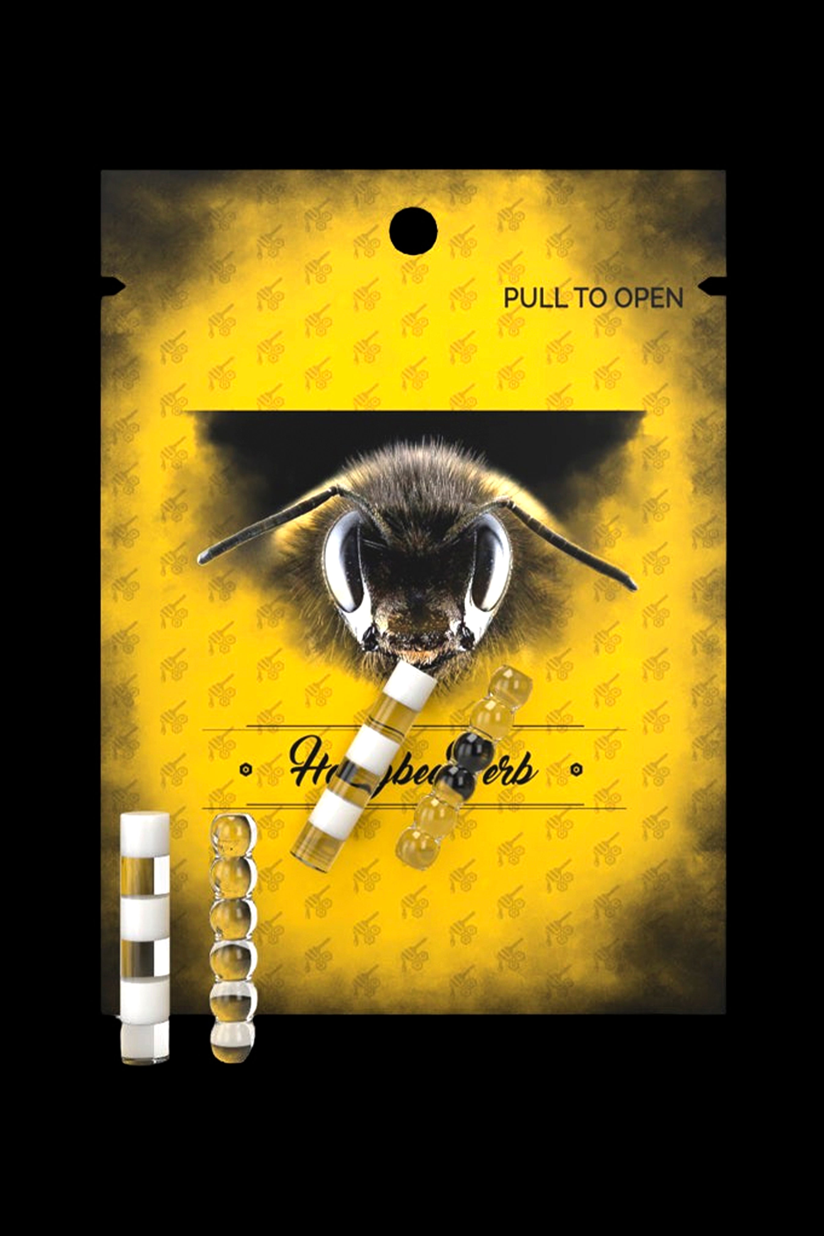 Yellow cannabis accessory packaging featuring a bee illustration and several small, gold-accented glass cartridges.