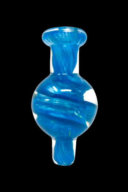 Blue glass dab cap with swirling patterns.