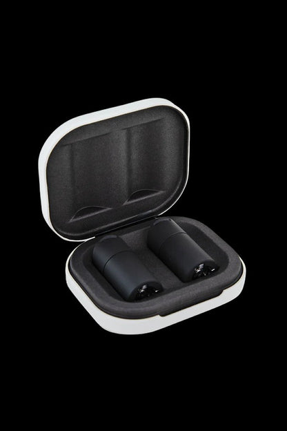 Open white and black carrying case with two cannabis vape pen cartridges inside.