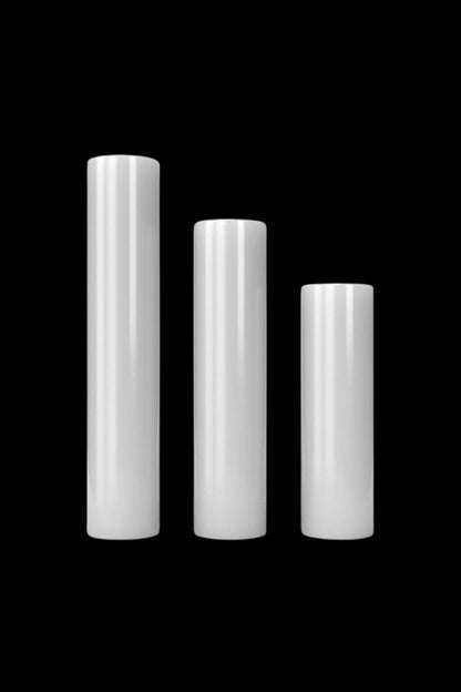 Three metallic, cylindrical smoking pipes of decreasing height against a black background.