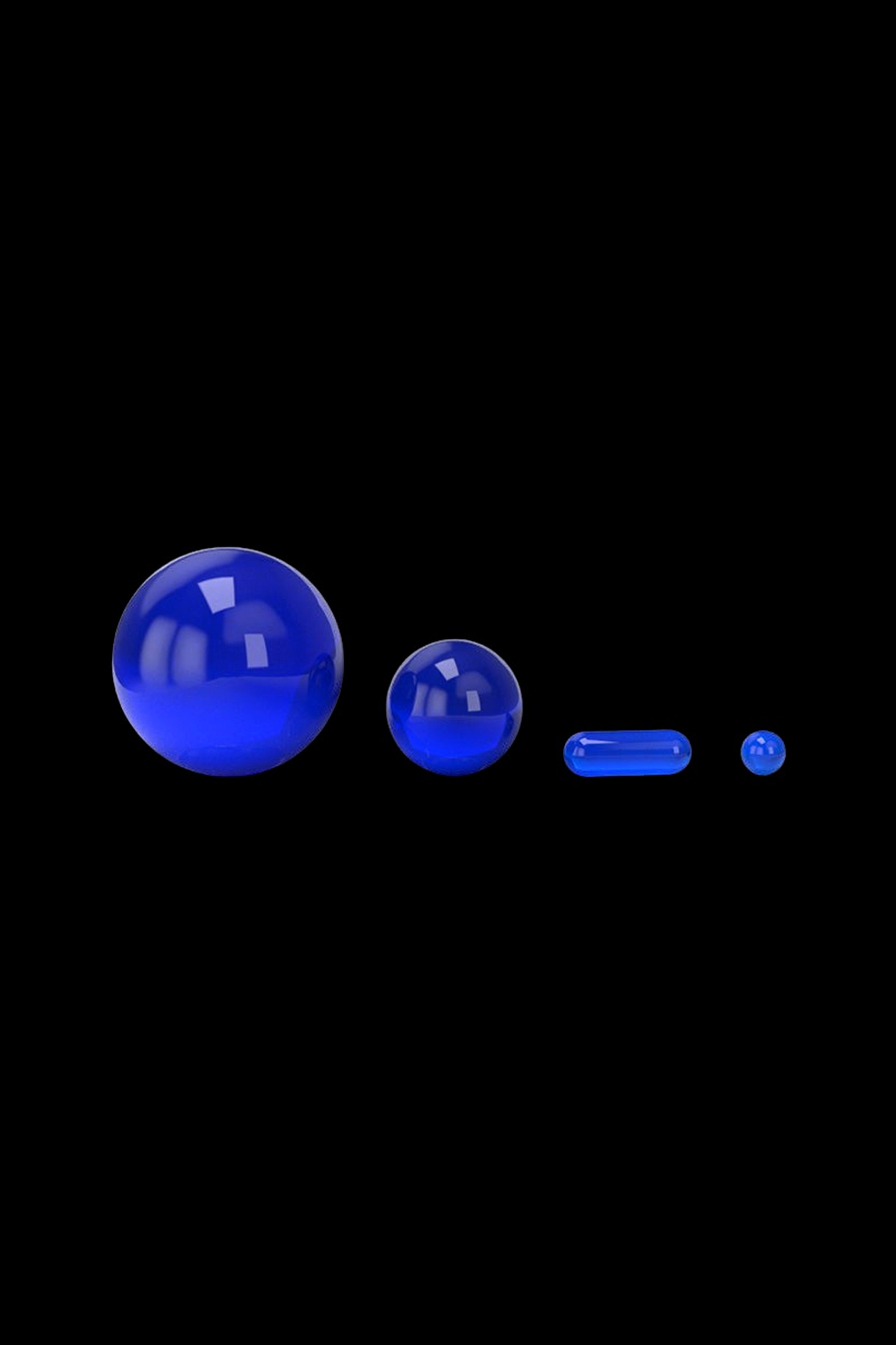Blue glass capsules and spheres against a black background.