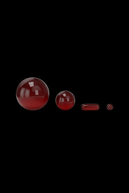 Red glass orbs and capsules against a black background, likely cannabis concentrate or oil containers.
