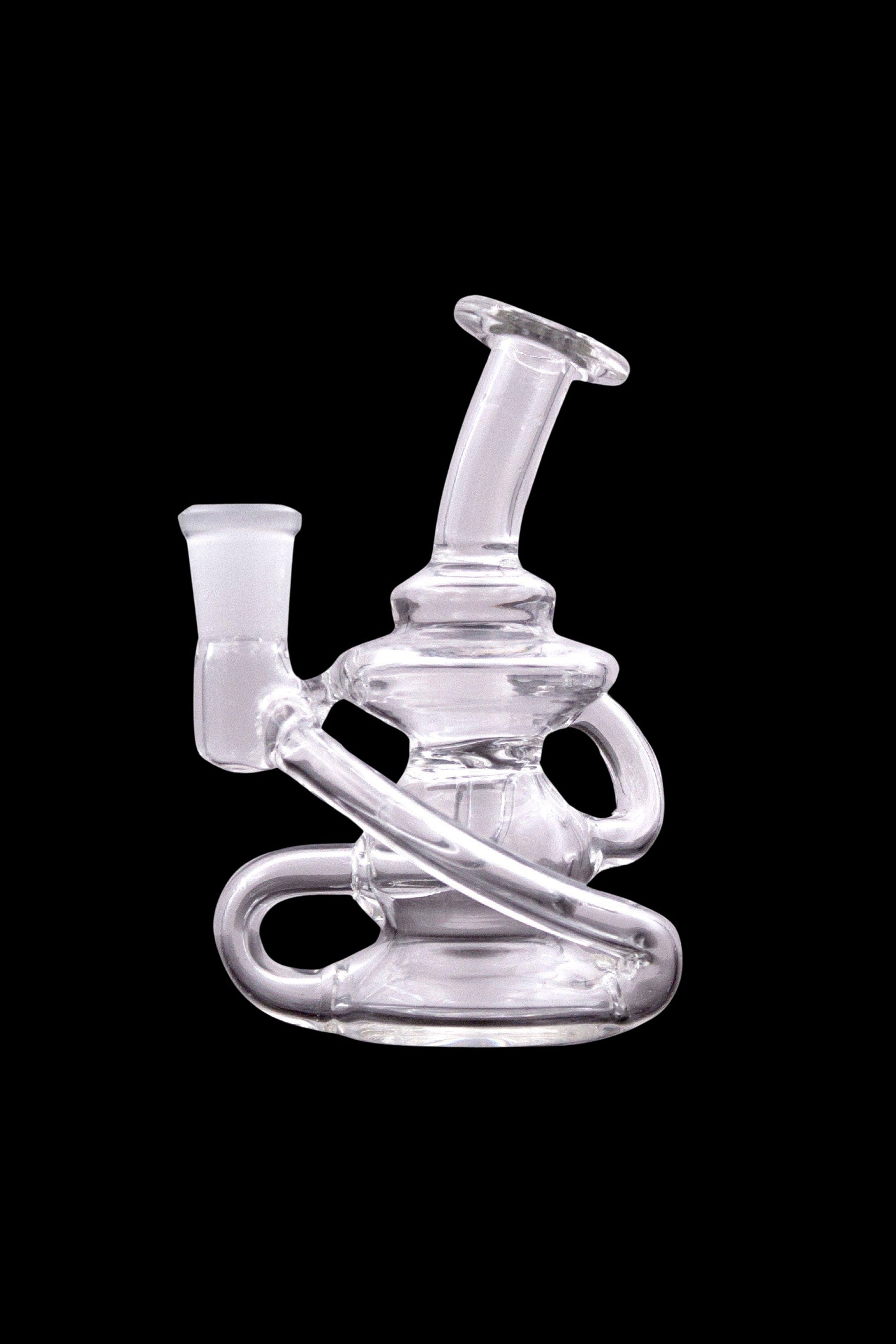 Clear glass water pipe (rig) with intricate looping design, isolated on a black background.