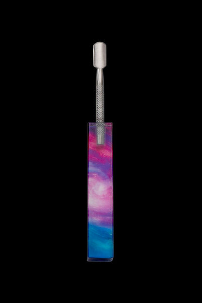 Cannabis dab tool in a colorful, nebula-patterned case against a black background.