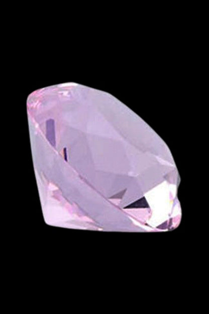 Close-up angled view of a faceted purple gem-shaped cap against a black background, the Stash Shack Diamond Cut Glass Carb Cap.