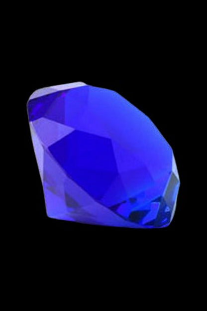 Close-up angled view of a clear blue faceted gem carb cap against a black background, The Stash Shack Diamond Cut Glass Carb Cap