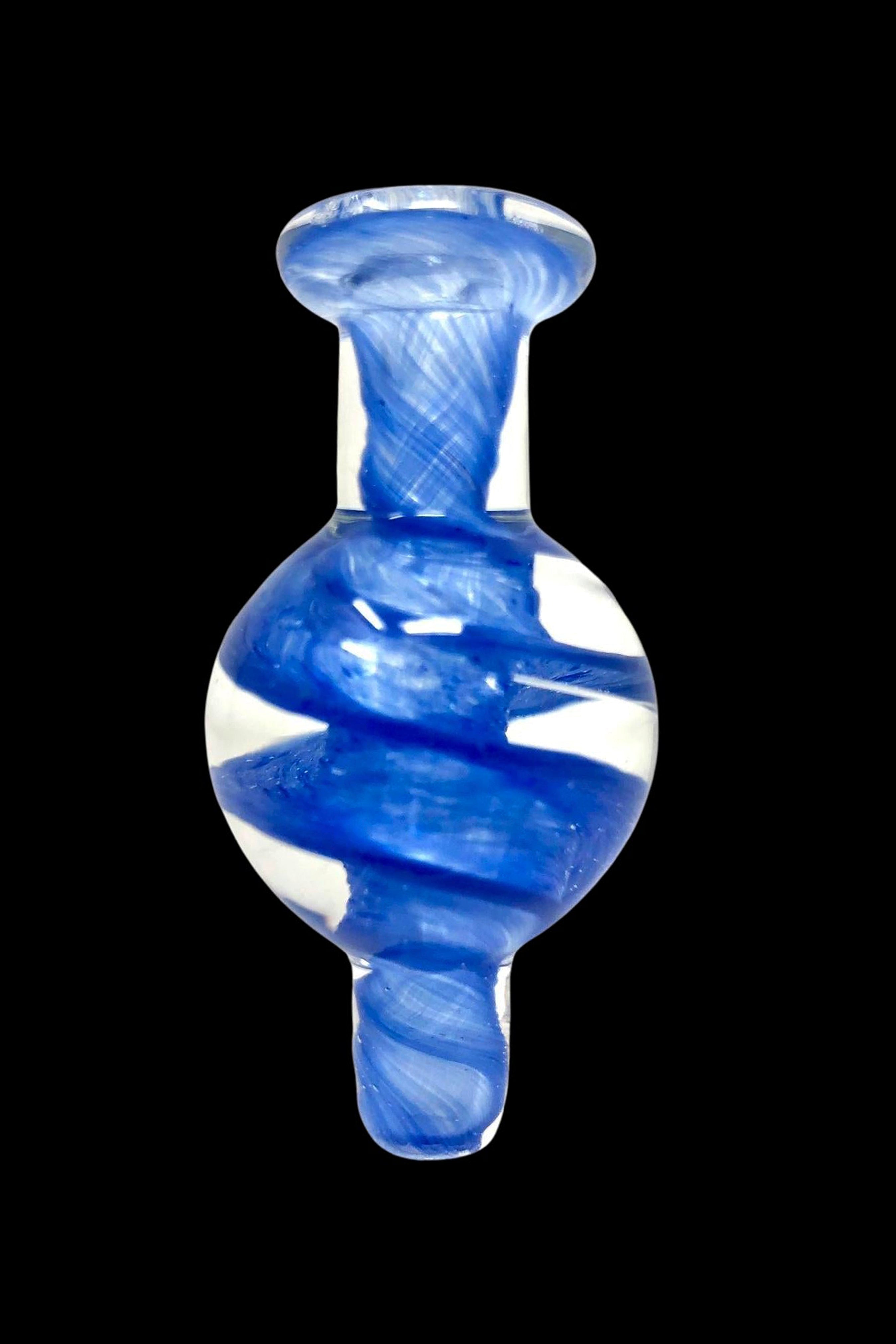 Blue glass dab cap with swirling white patterns.