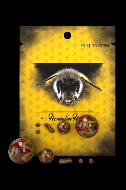 A yellow cannabis accessory bag with a bee graphic and scattered, colorful cannabis concentrates.