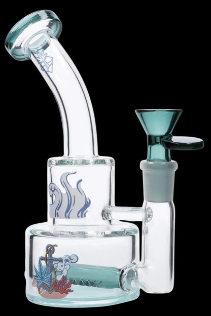 Angled close-up of the teal Cabana Cannabis Co. Ahoy Dab Rig showing its bent mouthpiece, dual-chamber body with wave and anchor artwork, and teal bowl against a black background