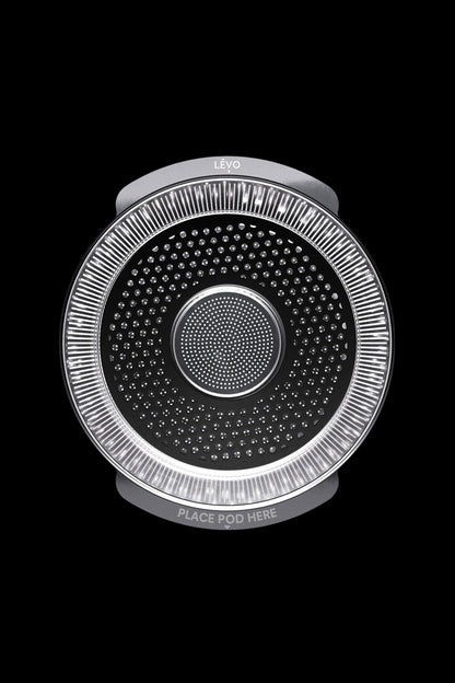 A Levo oil infusion device with a perforated stainless steel basket and illuminated ring, designed for cannabis or herbal extracts.