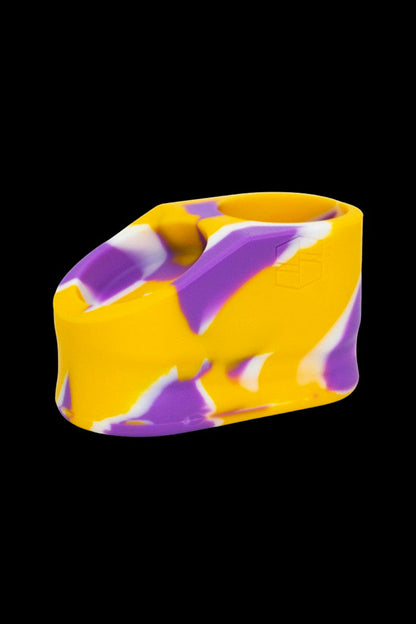 Yellow and purple silicone cannabis concentrate container.