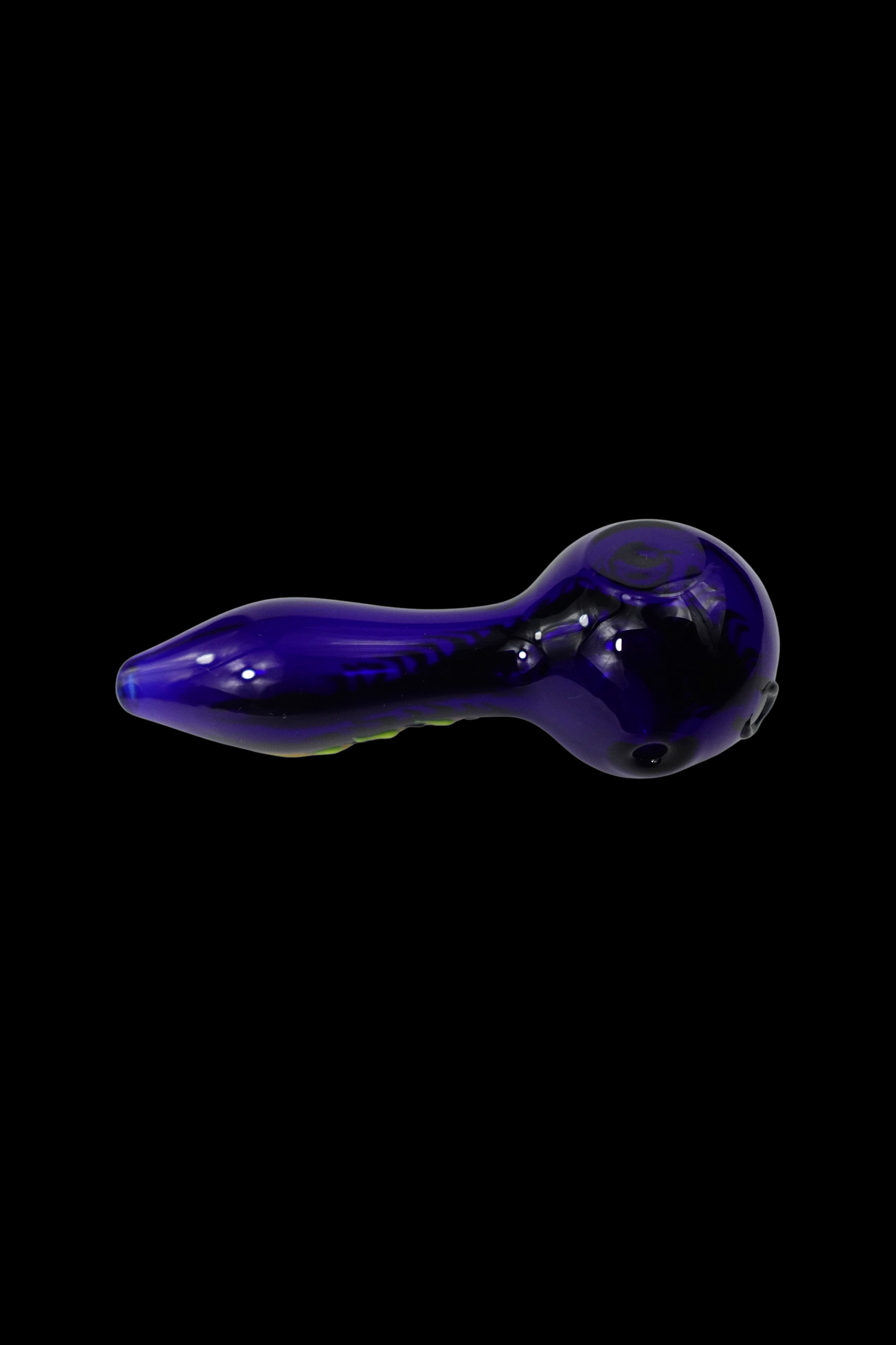 Purple glass smoking pipe isolated on a black background.