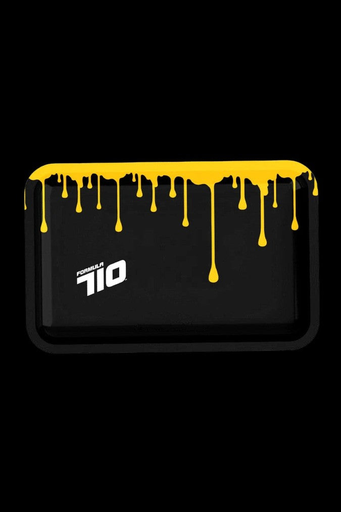 Black rectangular cannabis concentrate container with dripping golden oil and “Formula 710” text.