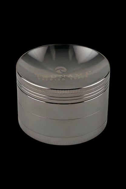 Black four-layer cannabis grinder with etched detailing.