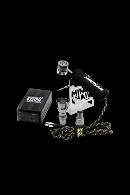 Cannabis dab rig accessories including an e-nail, quartz banger, carb cap, and storage container, displayed on a black background.