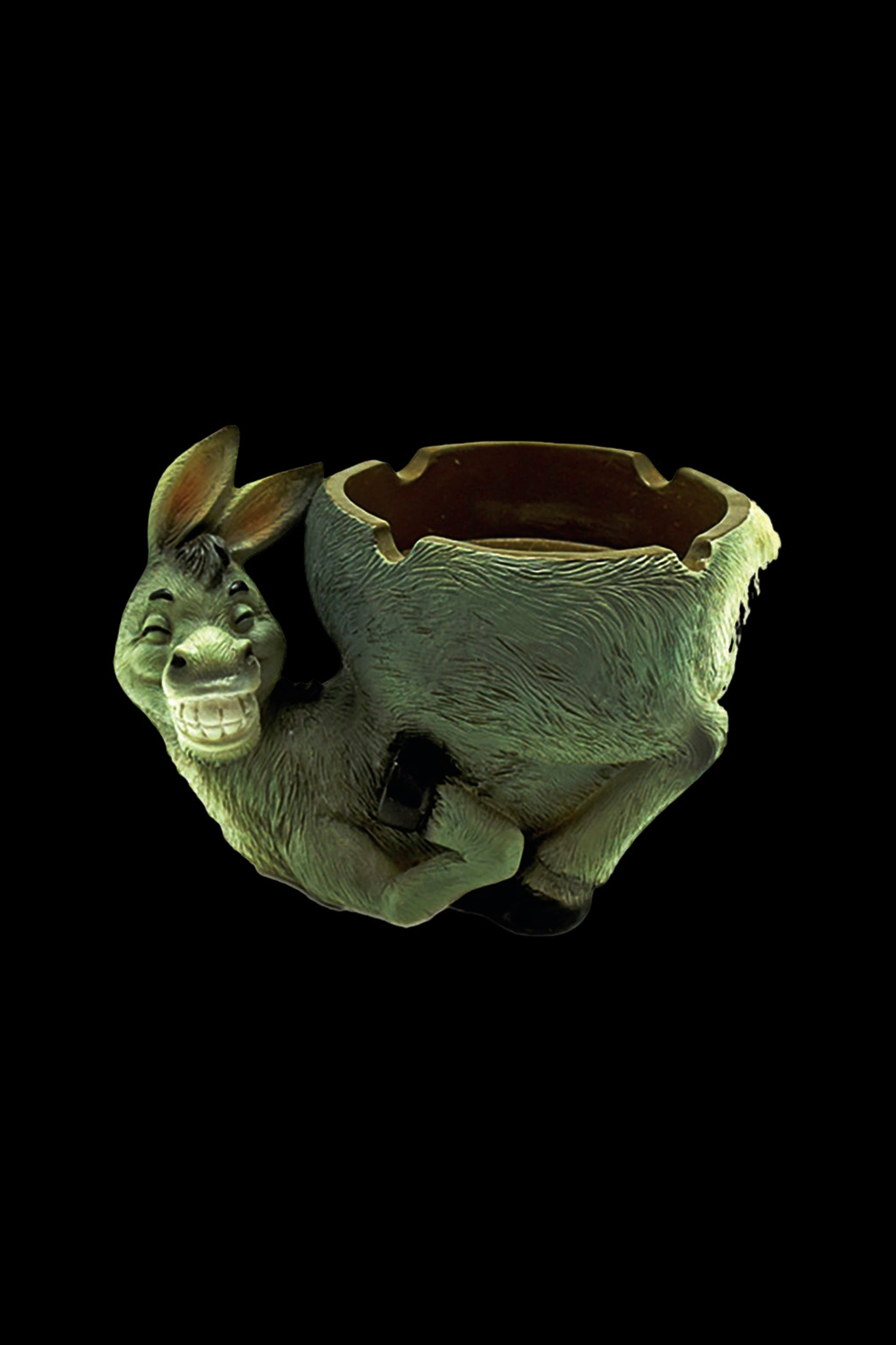 Ceramic donkey ashtray with a textured green finish, isolated on a black background.