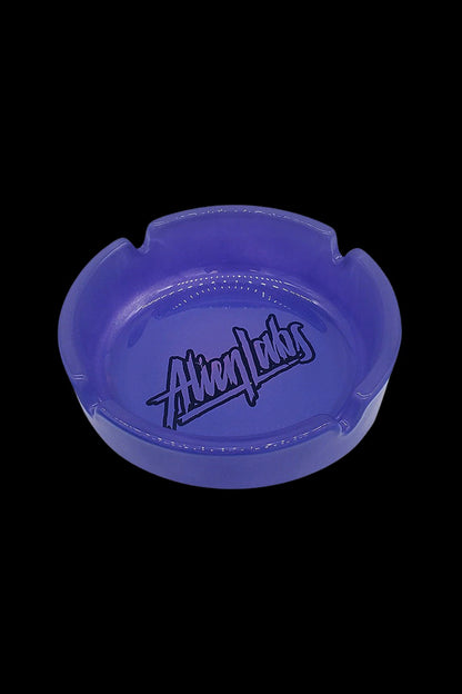 Blue glass ashtray with “Alien Labs” logo.