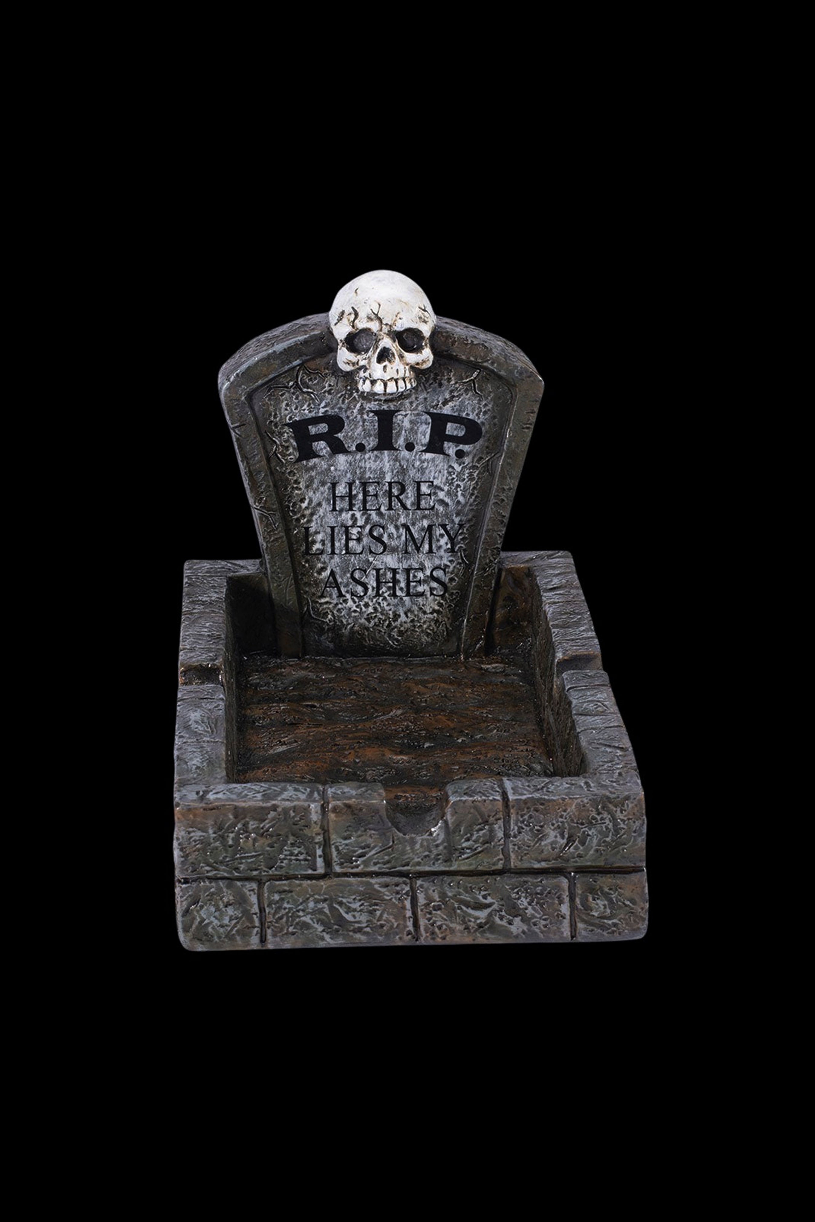 A spooky Halloween-themed ashtray shaped like a tombstone with “R.I.P. HERE LIES MY ASHES” inscribed on it.