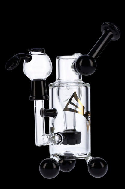 Clear glass water pipe (rig) with black accents and spherical base, studio shot.