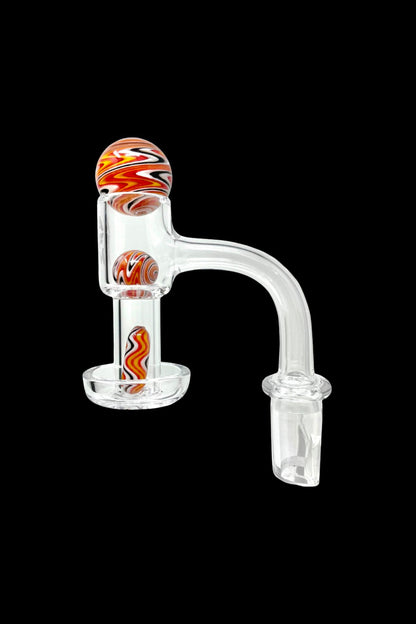 Clear glass dab rig with colorful patterned glass accents.