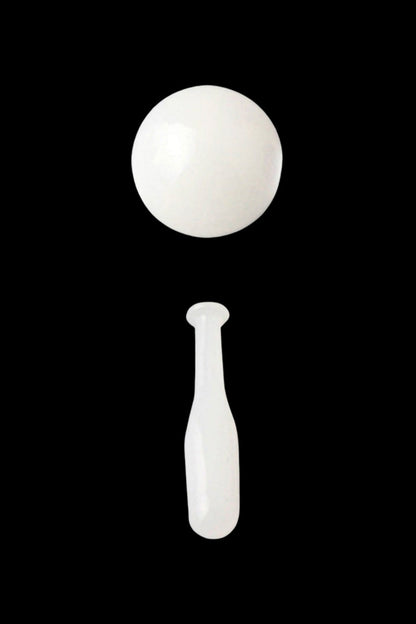 White dab tool with a spherical end and tapered stem against a black background.