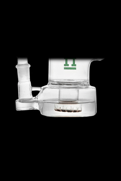 Clear glass dab rig with green logo, isolated on black.