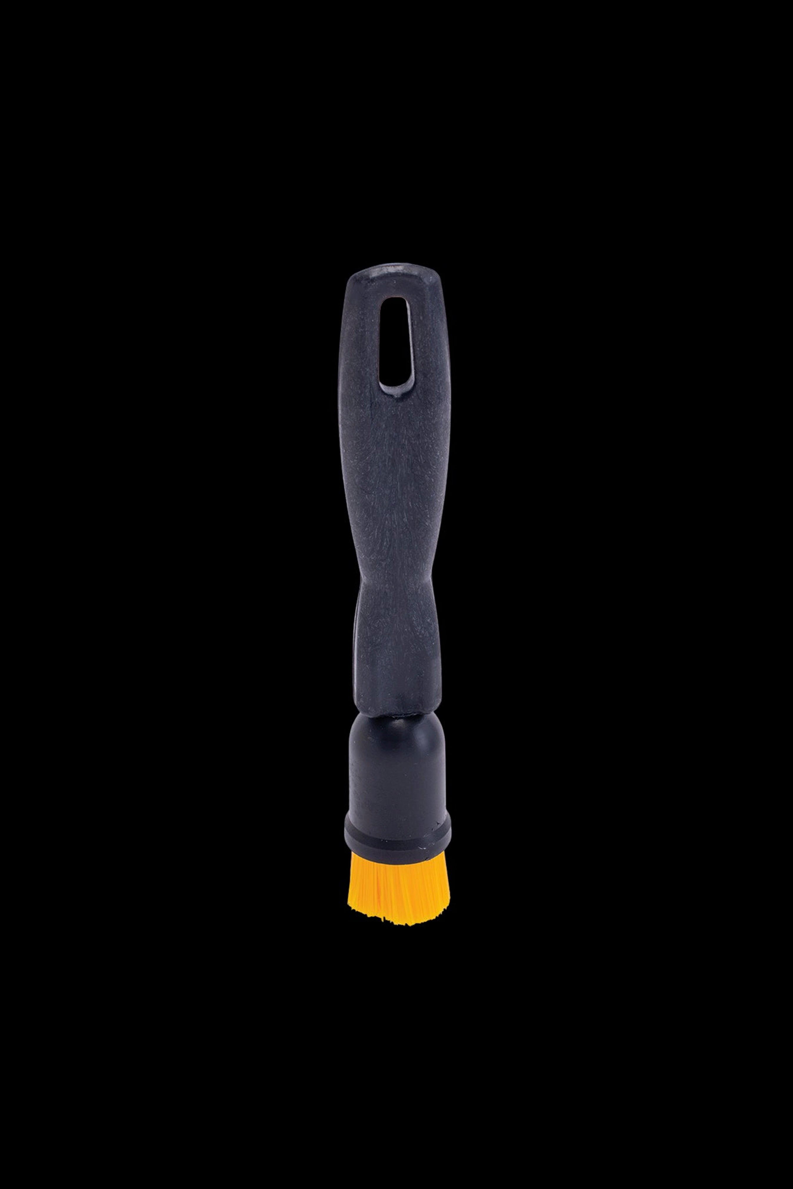 Black pipe cleaning brush with yellow bristles.