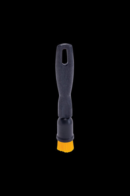Black pipe cleaning brush with yellow bristles.