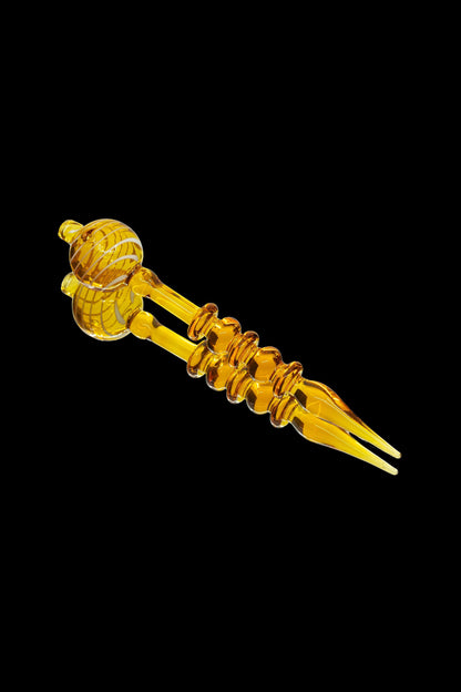 Amber glass dab tool with spherical and spiral accents.