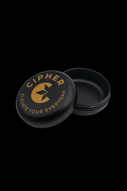 Black cannabis concentrate container with gold branding reading ""Cipher - Elevate Your Everyday."""