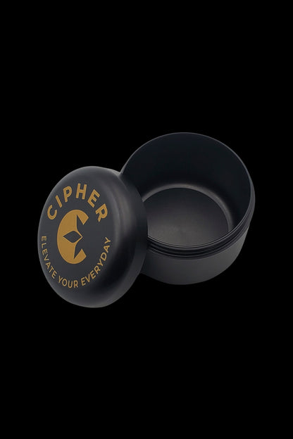 Black cannabis concentrate container with gold “Cipher” branding.