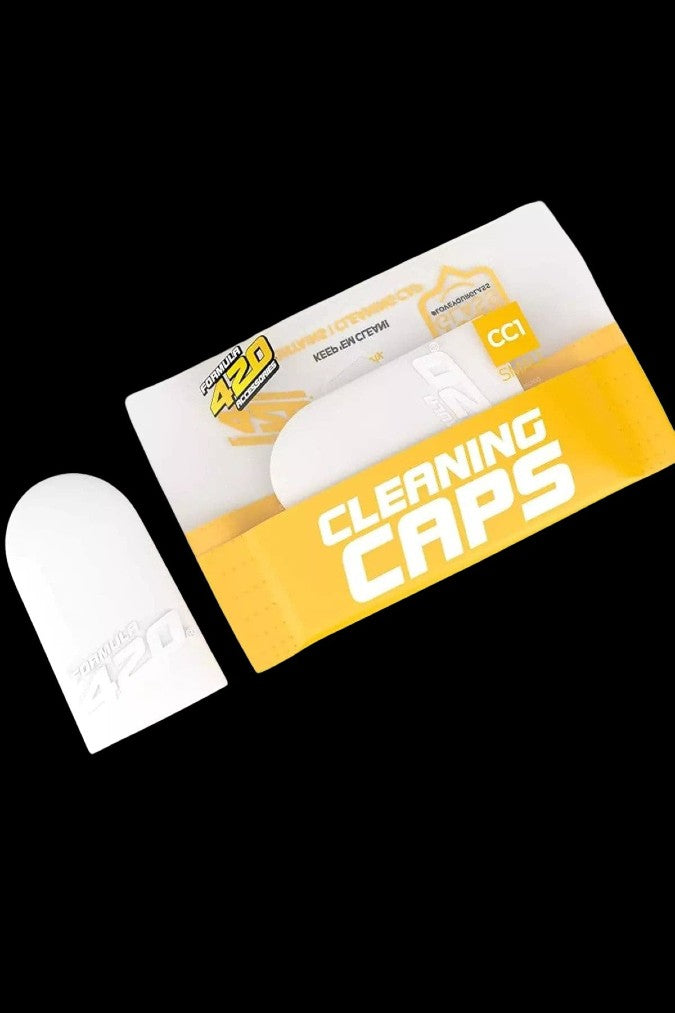Box of "Cleaning Caps" for cannabis accessories with a single white cap displayed.