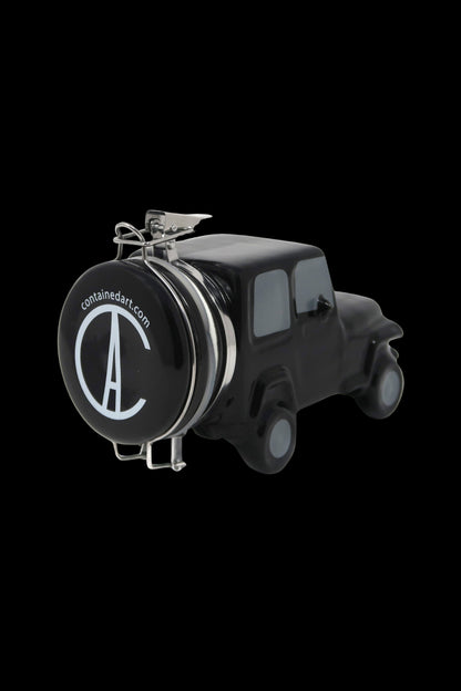 Black ceramic cannabis grinder shaped like a vintage van with “containedart.com” logo.