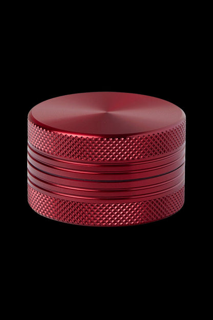 Red metal cannabis grinder.