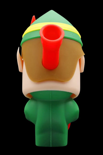 Cartoon elf figurine with a red pipe protruding from its face, set against a black background.