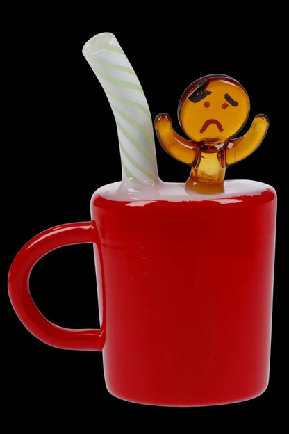 Red glass bubbler shaped like a mug with a miniature gingerbread man figure on top.