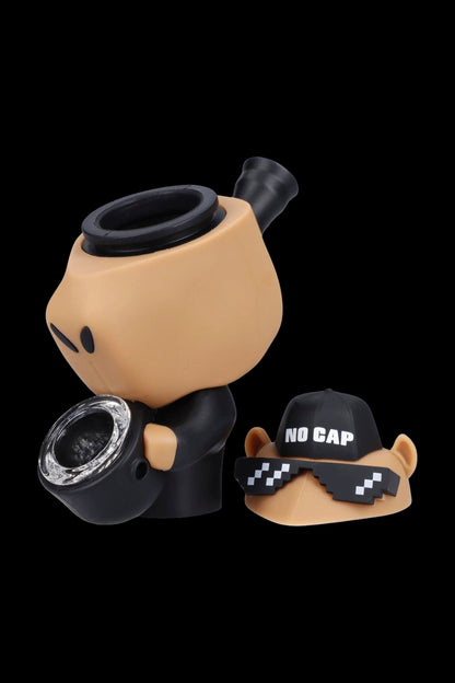 Cartoonish silicone cannabis pipe with “No Cap” baseball cap and pixelated sunglasses.