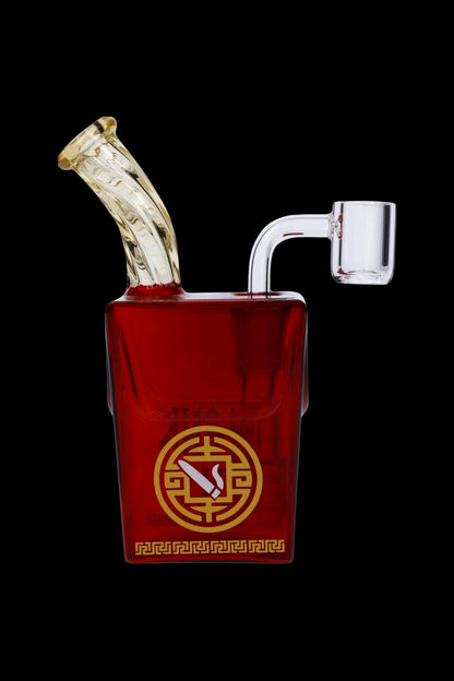 Red glass water pipe with ornate gold detailing and a clear mouthpiece, isolated on a black background.