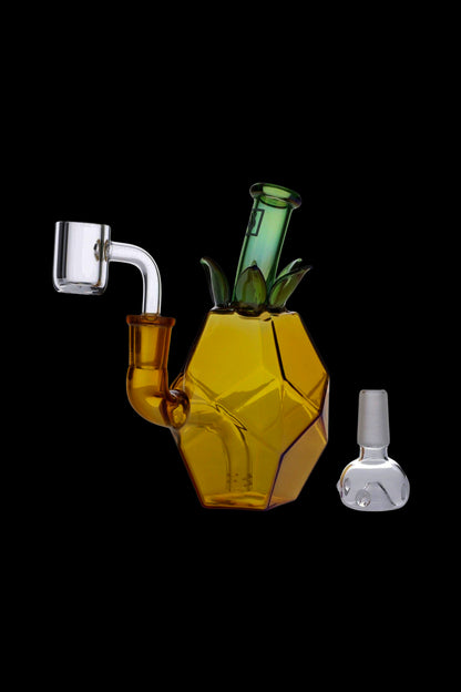 Honeycomb-shaped glass oil rig with accompanying glass carb cap and bowl, isolated on a black background.