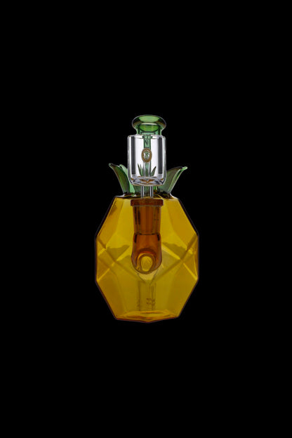 Golden glass cannabis oil rig with green accents, isolated on a black background.